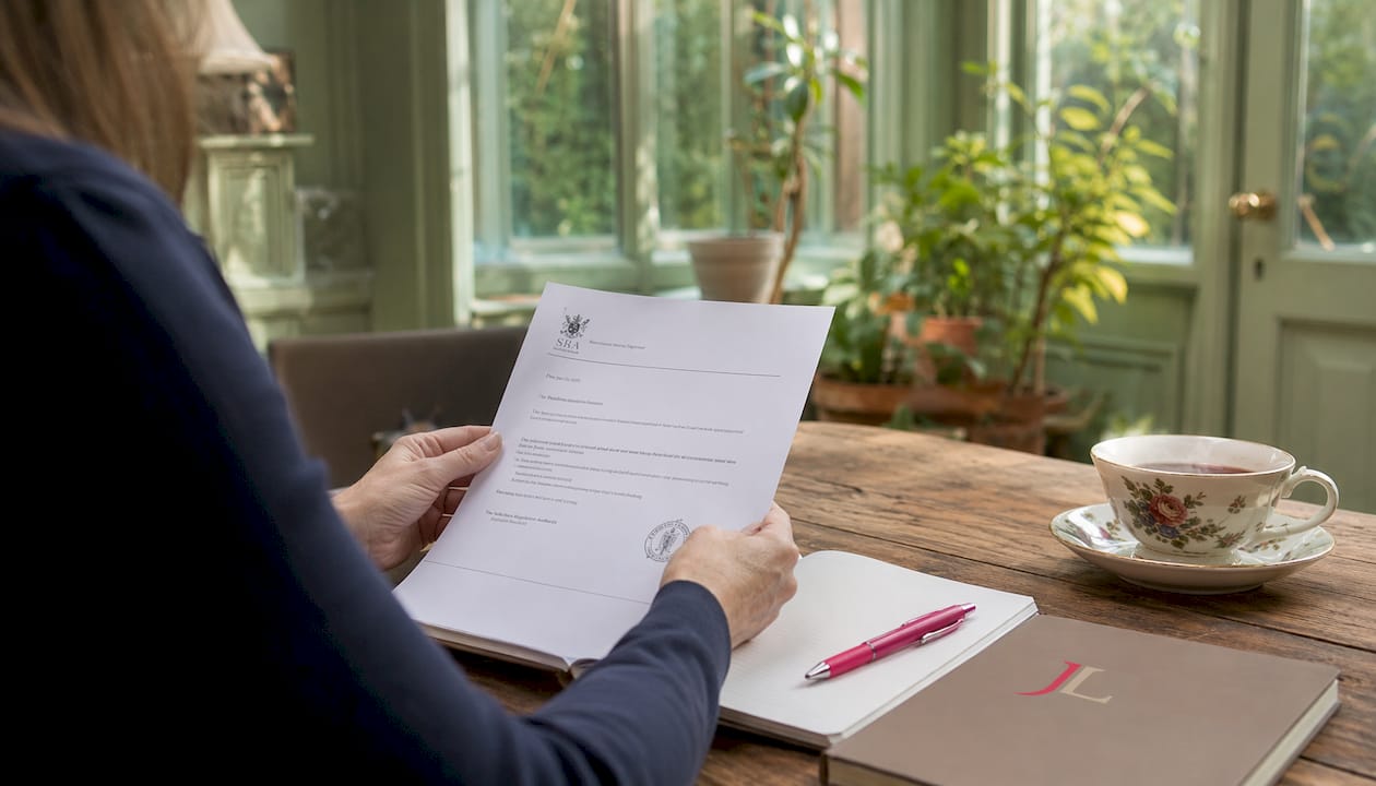 Hands holding legal document in home office