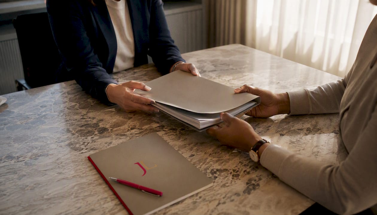 Hands holding legal file in UK solicitor office