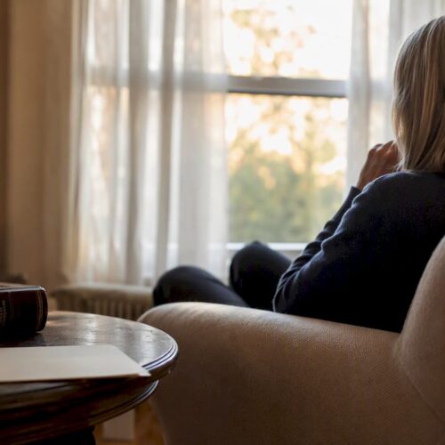 Silhouette in home with legal books and documents