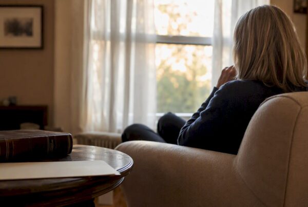 Silhouette in home with legal books and documents