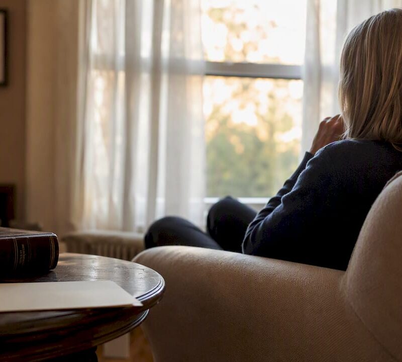 Silhouette in home with legal books and documents