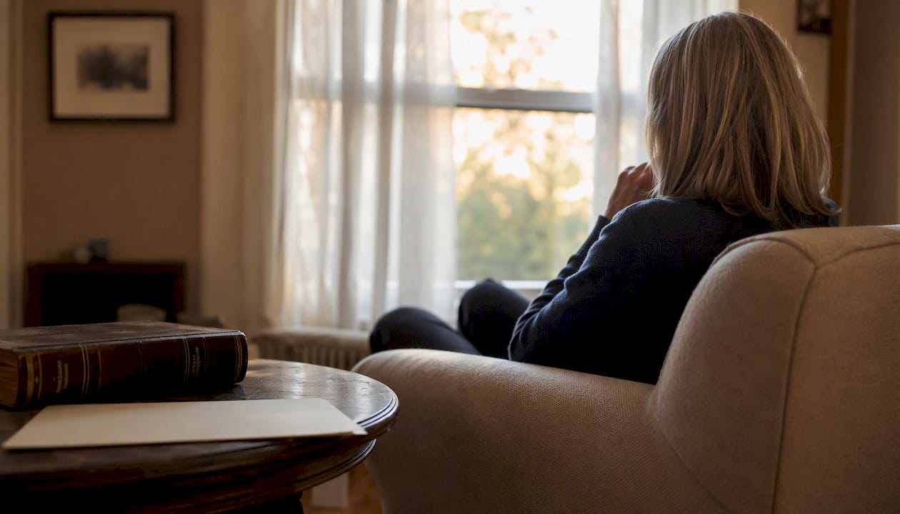 Silhouette in home with legal books and documents