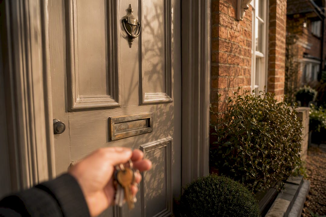 UK red-brick house front door with keys