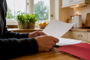 Hands holding blank estate documents